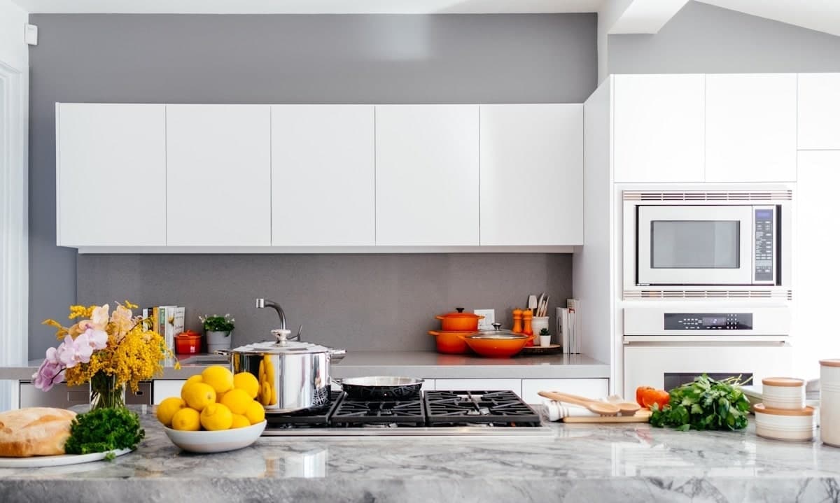 Bright, clean residential kitchen with white cabinets